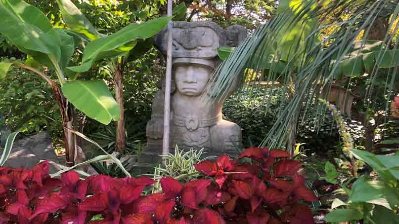 Japanese statue and red flowers