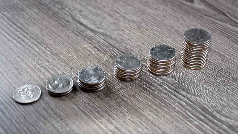 Stacks of quarters getting higher from left to right