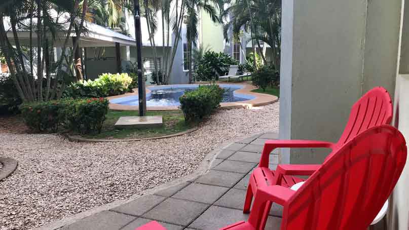 view of walkway and pool in the background