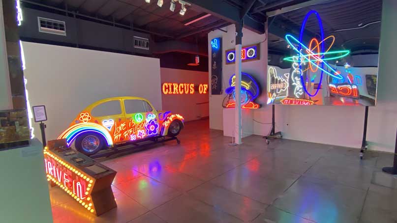 Room of neon signs - a car, building, signs
