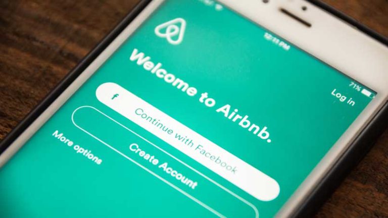 smart phone that says welcome to airbnb