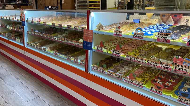 donut case in the store with many donut varieties