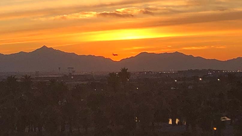 orange sky from sunset with plane flying