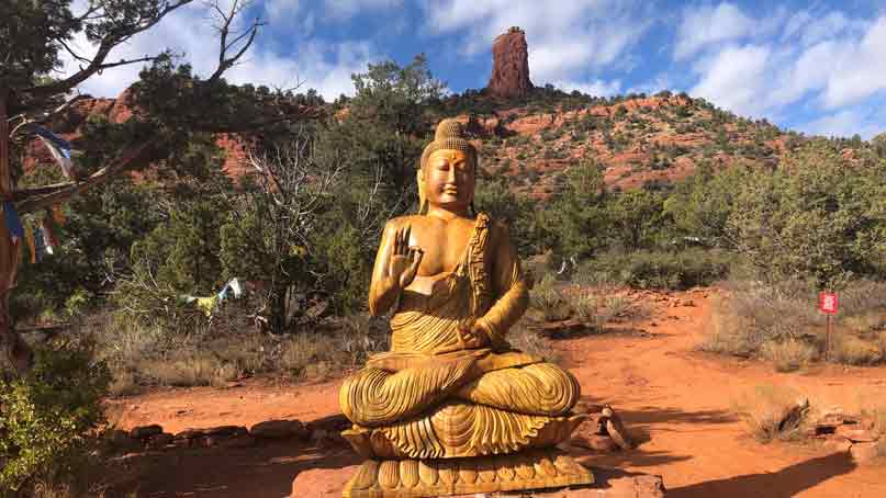 Budda in the foreground and a hill in the background
