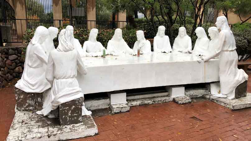 statues of men at a table - the last supper
