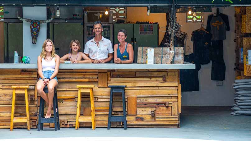 Photo of family standing behind a bar