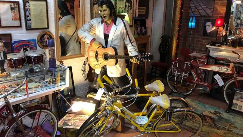 two beatles bicycles in front of elvis cutout