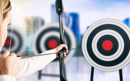 woman shooting an arrow at a bullseye