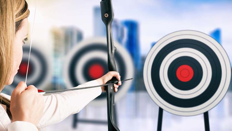 woman shooting an arrow at a bullseye