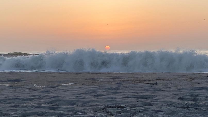 sunrise and crashing waves on the beach