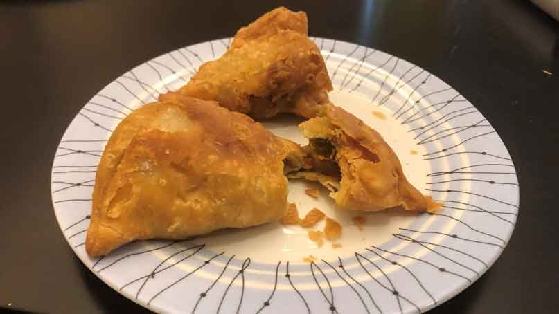 plate with a samosa that is cut open