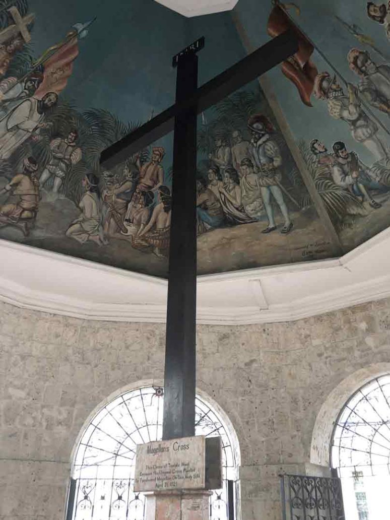 large cross with a plaque underneath that says Magellan's Cross