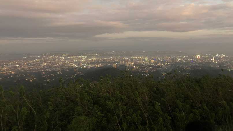 View of city down the hill and in the distance as dusk falls
