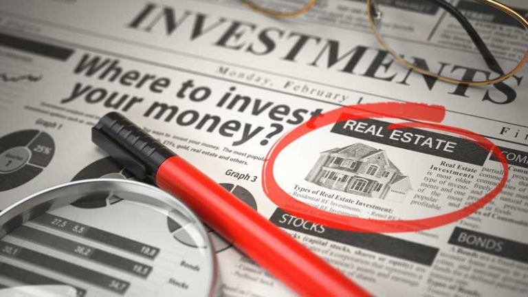investing newspaper with real estate in a circle