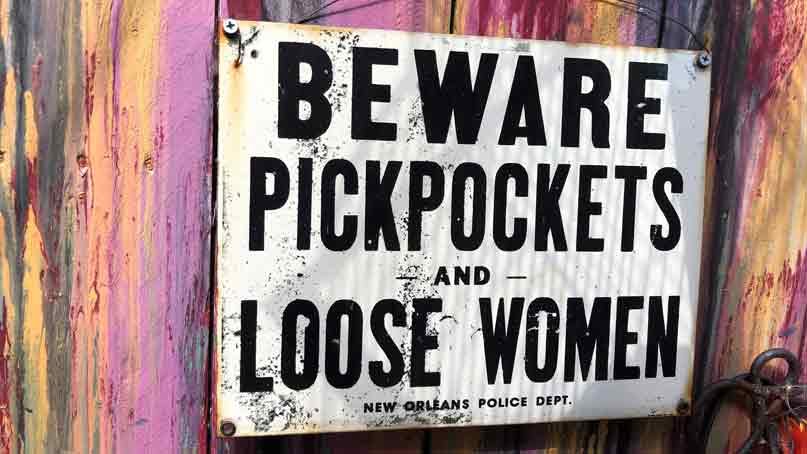 sign says beware pickpockets and loose women