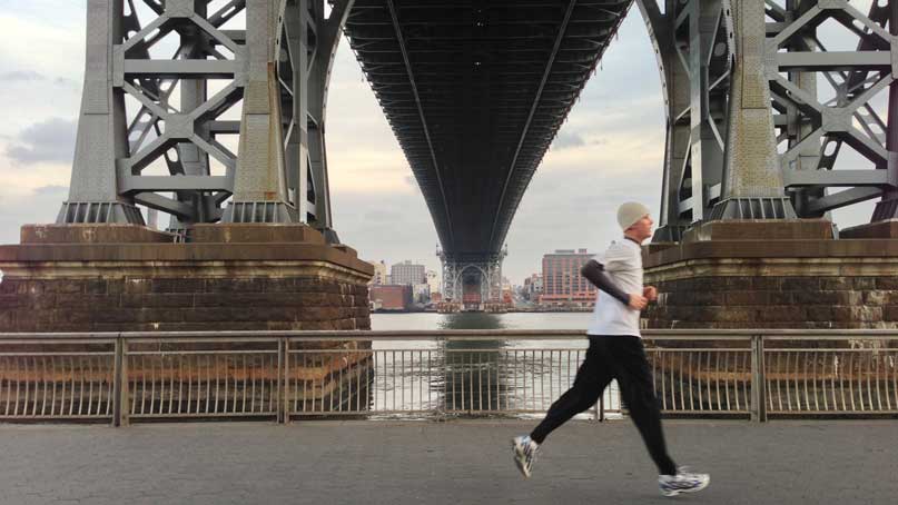runner going by under a bridge