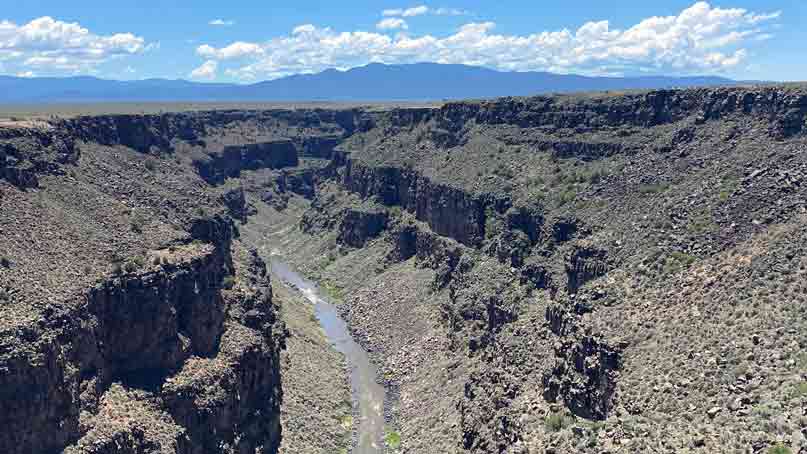 cliffs on the left and right with a river far down in the center