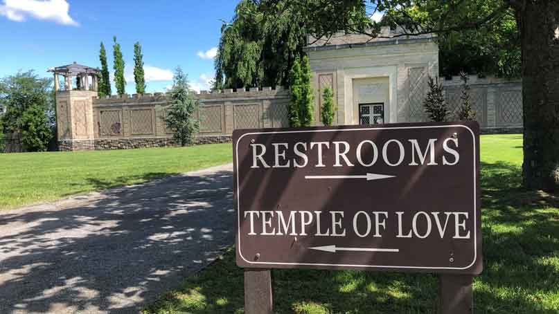 sign that says temple of love and bathroom in different directions