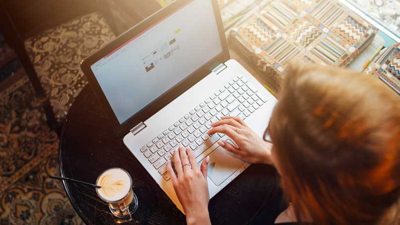 woman typing on laptop