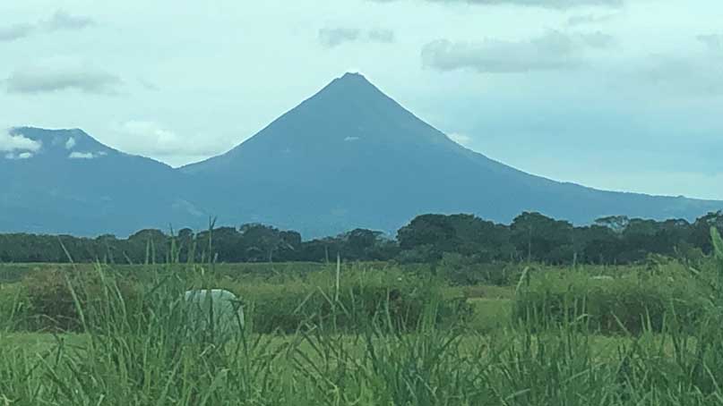 a volcano in the distance